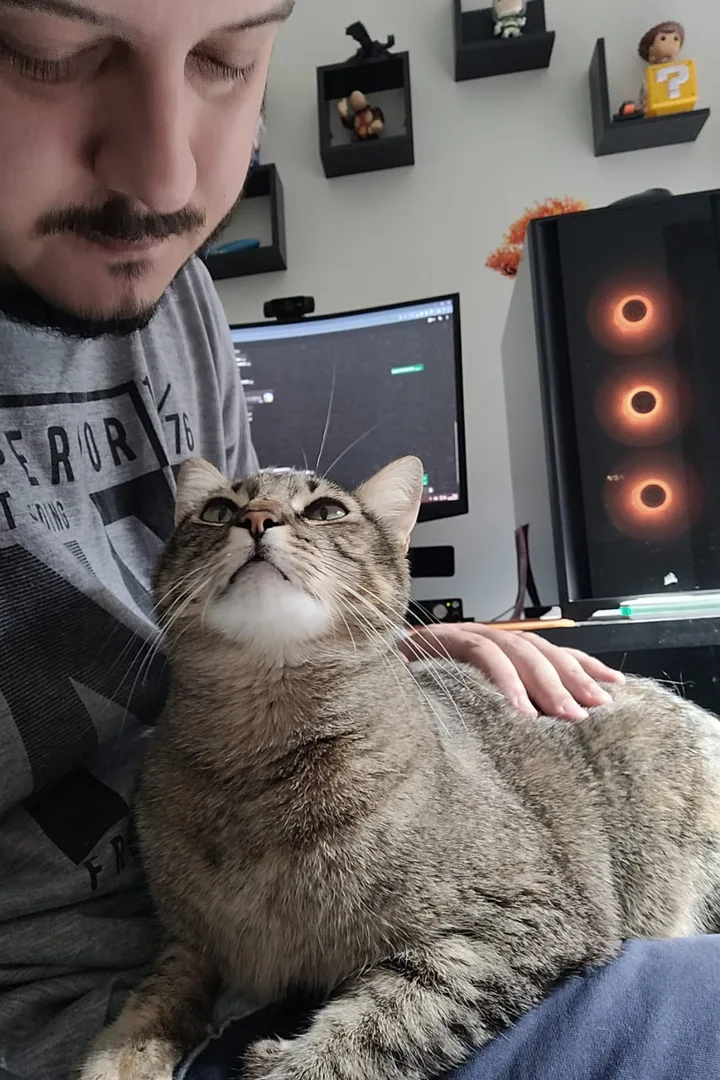 Breno and his cat at his desk