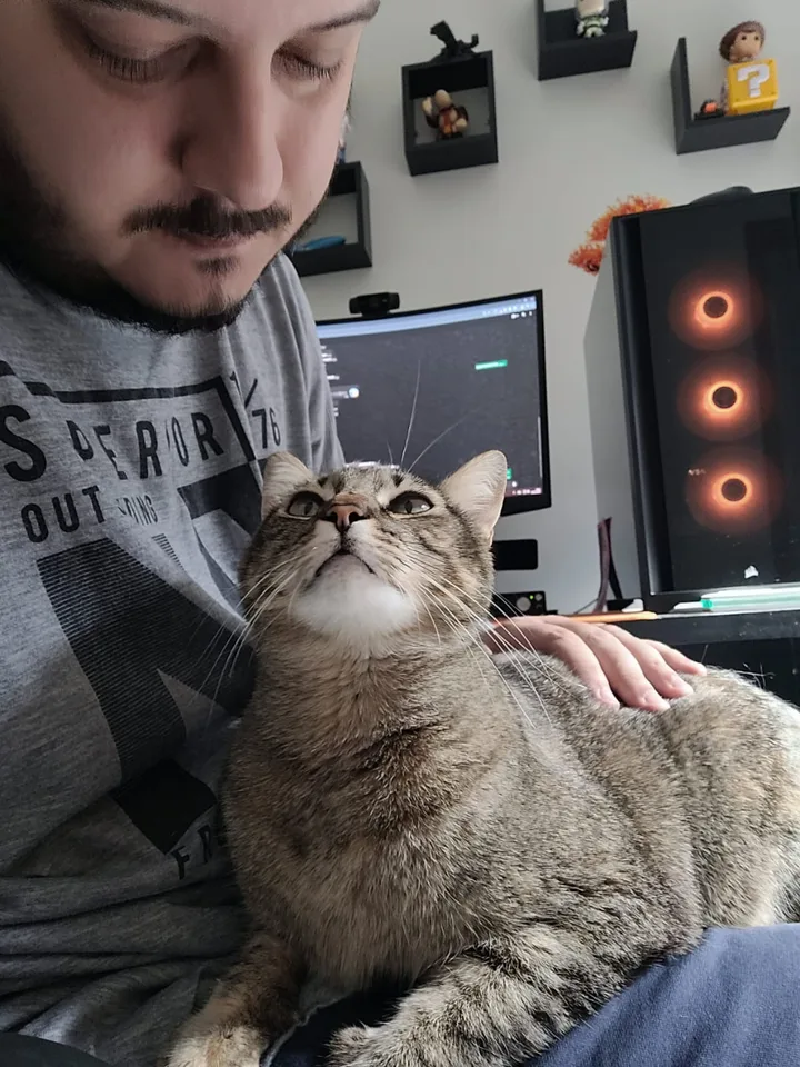 Breno and his cat at his desk